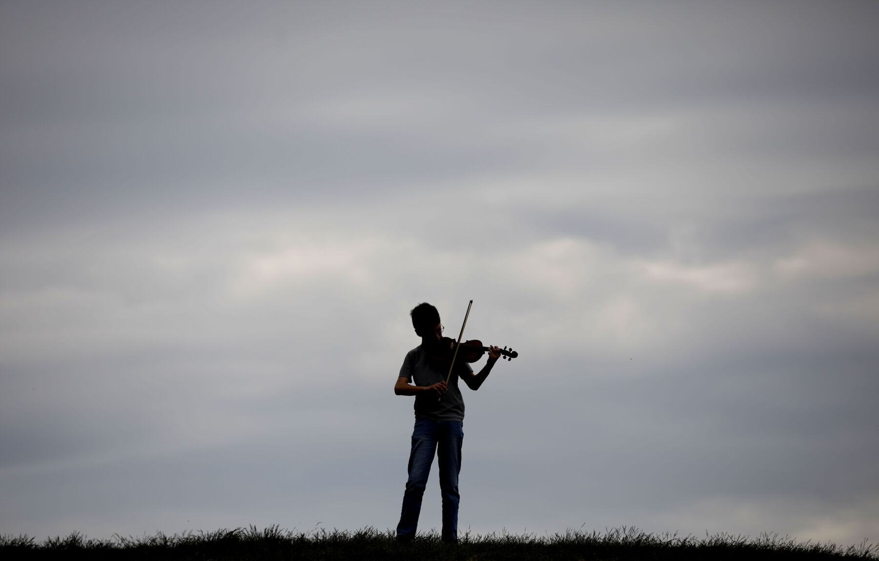 evan miller playing violin on hilltop